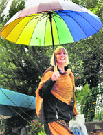 A foreign tourist walks with an umbrella after the curfew was lifted from Srinagar 
