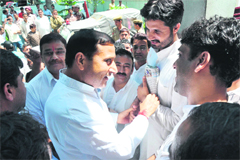 Minister for Health Sham Lal Sharma talks to activists of the PYC at Jammu city police station