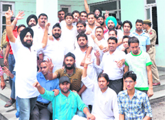Activists of the PYC raise slogans outside the city police station in support of their demand for the transfer of the SSP and a DSP in Jammu