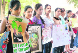 Students form a human chain to save environment at MCM DAV College in Sector 36, Chandigarh, on Wednesd