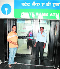 A security guard on duty in front of an SBI ATM in Sector 30, Chandigarh, on Wednesday
