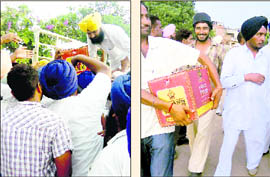 A party worker distributes cartons of liquor during a public gathering addressed by Punjab Deputy Chief Minister Sukhbir Singh Badal in Mohali on Wednesday; and (right) a man carries a carton