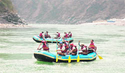 Tourists enjoy rafting on the Ganga with camps in the background and (right) two rafting camps on the banks of the river near Rishikesh
