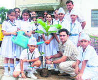 Students plant saplings to mark World Earth Day in Tagore International Senior Secondary School, Sahnewal, on Wednesday. 