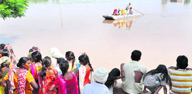 Residents of flooded Kambko-ke village, adjacent to a dhussi bundh along the Sutlej, are taken to safe places on Wednesday. 