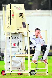 Kevin Pietersen sits on a bowling machine during a training session at Lords cricket ground in London