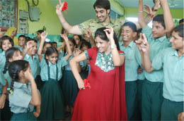 Punjabi singer Miss Pooja dancing with students of the Mahant Gurbanta Dass school for 