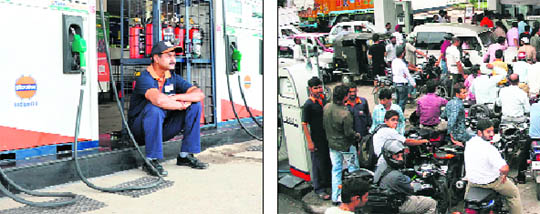An employee sits idle at a filling station in Jammu on Thursday; and (right) panicky vehicle owners converge on a station to buy petrol. 