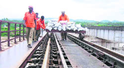 An advance party of railway officials inspects the track over the Balole Nullah Bridge at Bari Brahmana in Samba district on Thursday. 