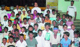 Poor kids were given gifts on the occasion of the birth centenary of Sister Alphonsa and Mother Teresa in Trinity College.