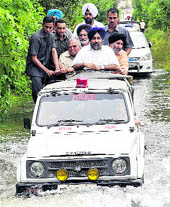 Deputy CM Sukhbir Badals motorcade passes through a flooded street at Anandpur Sahib on Thursday