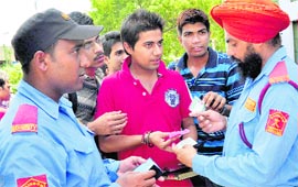 Security guards check identity cards of students ahead of the PU elections at DAV College in Sector 10, Chandigarh, on Friday.