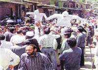Supporters of the sacked Congress Minister, GM Saroori, protest at Chatroo town in Kishtwar district on Friday.