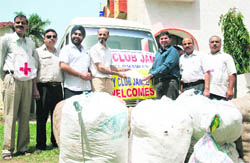Members of Rotary Club, Jammu Tawi, hand over relief material for Ladakh victims to the Red Cross Society in Jammu on Friday. 
