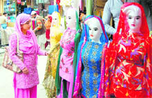 A girl busy shopping in a market after the lifting of the curfew in Srinagar on Friday.