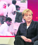 German Chancellor Angela Merkel sits in front of a video wall during a live TV show Help for Pakistan in Berlin.