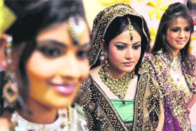Models display bridal wear at a bridal make-up workshop in Amritsar