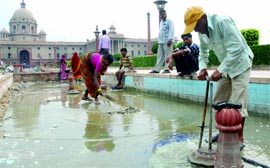 Labourers at work at North Block ahead of the Commonwealth Games in New Delhi on Saturday.