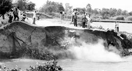 Villagers at the site of a breach in Kunda Kalan village of Karnal on Saturday.