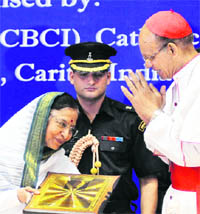 President Pratibha Patil receives a memento from archbishop of Mumbai, Cardinal Oswal Gracias, at a function to mark the birth centenary celebrations of Mother Teresa, in New Delhi on Saturday.