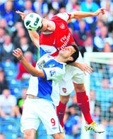 Blackburn Rovers' Nikola Kalinic vies with Arsenal's Thomas Vermaelen (up) during the English Premier League football match between Blackburn Rovers and Arsenal at Blackburn, England, on Saturday.