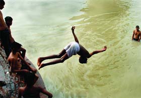Children play in the flooded Yamuna at Shastri Park in New Delhi