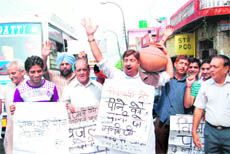 Activists of the Jammu West Assembly Movement protest against PHE against acute scarcity of drinking water in the New Plot area of Jammu on Sunday.
