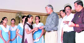 Members of the Bharat Vikas Parishad distribute scholarships to needy girl students in Ludhiana on Sunday.