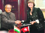 Federal Councillor Head of the Federal Department of Foreign Affairs of Switzerland Micheline Calmy-Rey (R) and Finanace Minister Pranab Mukherjee shake hands after signing a protocol in New Delhi on Monday. The two ministers signed a protocol amending the existing Double Taxation Avoidance agreement. 
