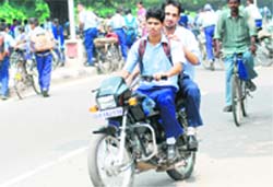 School students continue to violate traffic rules by riding without helmet. This photograph was clicked by Tribune lensman S Chandan on the road separating Sectors 10 and 11 in Chandigarh
