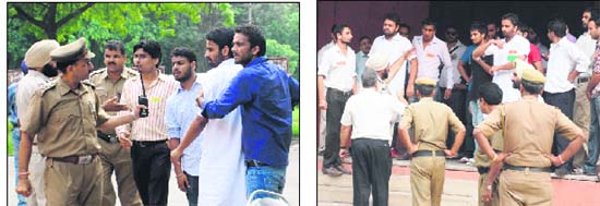 Security personnel try to pacify SOPU (left) and PUSU activists outside the law department of Panjab University