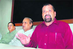 Trivendra Singh Pawar, President of the Uttarakhand Kranti Dal, addresses a press conference in Dehradun on Monday.