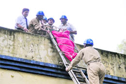 Civil defence personnel conduct a mock drill in Dehradun on Monday.