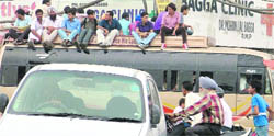 This happens only in India: Commuters sit atop an overcrowded bus in Ludhiana.