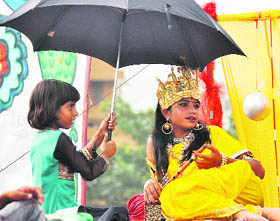 A child artiste, dressed up as Lord Krishna, all ready for a shobha yatra.