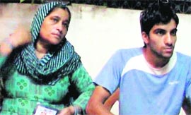 Somwati, mother of kidnapped youth Pradeep, with her younger son at their home in Kurukshetra on Tuesday.