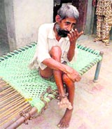 Gurdeep Singh chained to his charpoy at his house in Panniwala Ruldu village in Sirsa.
