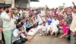 Residents of Sherpur Kalan and Dhandari Khurd stage protest at focal point road, with the body of the gastro victim lying on road