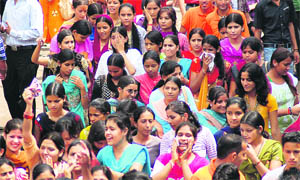 Girl students of DAV College take part in an election rally in Dehradun on Wednesday.