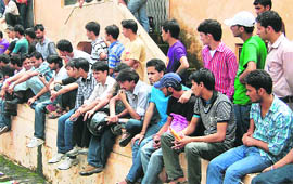 Students watch a rally from the sidelines at DAV College, Dehradun, on Wednesday.
