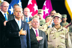 (From left): US Vice-President Joe Biden, US Secretary of Defence Robert Gates and Chairman of the Joint Chiefs Admiral Mike Mullen pledge allegiance as the US National Anthem is played during the change of command ceremony in Baghdad on Wednesday