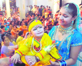 A child dressed as Lord Krishna at a temple during Janmashtami celebrations in Dehradun on Thursday.