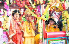 Children dressed up as Krishna and Radha during a Janmashtami procession in Sainik Colony in Jammu on Thursday.