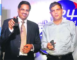 Sandeep Singhal (L) National Head (sales & distribution) of Tata Docomo with Mayur Toshniwal CEO of T24 displaying T24GSM mobile phones during the company's service launch in West Bengal Telecom Circle in Kolkata on Friday. 