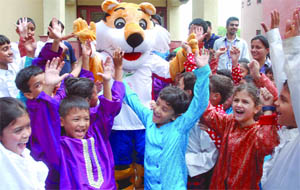 Shera, the mascot of the Commonwealth Games, enjoys with the students of Sanskriti School during the launch of Shera Mera Dost, a campaign to promote the mega sports event, in New Delhi on Friday.
