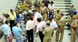 Policemen along with the bomb disposal squad carry out a mock drill at Rajiv Chowk Metro station in New Delhi on Saturday.
