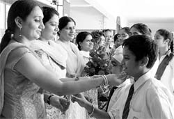Students offer flowers to their teachers in Ludhiana on Saturday