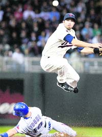 Texas Rangers Michael Young (below) is forced out at second by Minnesota Twins shortstop JJ Hardy during the eighth innings of their American League baseball game in Minneapolis