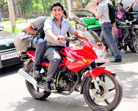 A schoolboy flouts road safety norms by not wearing helmet in Chandigarh
