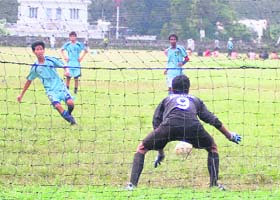 A goalkeeper defends a shot during a match at the Senior Council Football Tournament in Dehradun